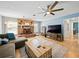 Spacious living room with tile flooring, fireplace, ceiling fan and neutral paint colors at 9019 Oakwood Dr, Lake Wales, FL 33898