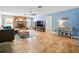 Spacious living room with tile flooring, fireplace, ceiling fan and neutral paint colors at 9019 Oakwood Dr, Lake Wales, FL 33898