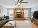Spacious living room with tile flooring, fireplace, ceiling fan and neutral paint colors at 9019 Oakwood Dr, Lake Wales, FL 33898
