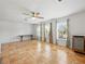 Bright living area with large windows, tile floors, and a ceiling fan for comfortable living at 9019 Oakwood Dr, Lake Wales, FL 33898