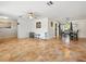 Open-concept living area with tile flooring seamlessly connecting to the dining area and kitchen at 9019 Oakwood Dr, Lake Wales, FL 33898