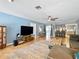 Inviting living room with tile floors, ceiling fan, and an open floor plan concept to the kitchen area at 9019 Oakwood Dr, Lake Wales, FL 33898