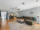 Spacious living room featuring a ceiling fan, comfortable seating, and an open concept leading to the kitchen at 9019 Oakwood Dr, Lake Wales, FL 33898