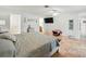 Bright main bedroom with ceiling fan, tiled floors, and television at 9019 Oakwood Dr, Lake Wales, FL 33898