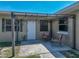 Cozy outdoor patio area with seating, string lights and view to the backyard at 9019 Oakwood Dr, Lake Wales, FL 33898