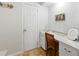 Charming vanity with white cabinets and tiled floors near the main bedroom at 9019 Oakwood Dr, Lake Wales, FL 33898