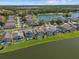 Beautiful lakefront home features a screened pool and well-manicured lawn at 936 Lake Berkley Dr, Kissimmee, FL 34746