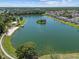 Scenic aerial view of lake with beach area and walkway at 936 Lake Berkley Dr, Kissimmee, FL 34746