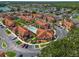 Aerial shot of a colorful condo community featuring a sparkling pool and ample parking at 936 Lake Berkley Dr, Kissimmee, FL 34746