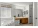 Bathroom featuring a soaking tub, vanity with drawers, and large mirror at 936 Lake Berkley Dr, Kissimmee, FL 34746