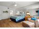 Bright bedroom with wood floors, ceiling fan, and large mirrored wall at 936 Lake Berkley Dr, Kissimmee, FL 34746