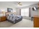 Bright bedroom featuring a large window, soft carpet and stylish furnishings at 936 Lake Berkley Dr, Kissimmee, FL 34746