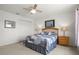 Comfortable bedroom features a decorative quilt, ceiling fan and wall art at 936 Lake Berkley Dr, Kissimmee, FL 34746