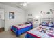 Bedroom with twin beds, cartoon themed bedding, and a ceiling fan at 936 Lake Berkley Dr, Kissimmee, FL 34746