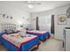 Bedroom with twin beds, cartoon themed bedding, and a ceiling fan at 936 Lake Berkley Dr, Kissimmee, FL 34746