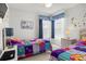 Bedroom with twin beds, colorful bedding, and light wood dresser at 936 Lake Berkley Dr, Kissimmee, FL 34746