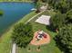 Overhead view featuring lakeside park with playground, beach volleyball and a gazebo at 936 Lake Berkley Dr, Kissimmee, FL 34746