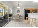 Cozy breakfast nook featuring a dining table, breakfast bar, and sliding glass doors at 936 Lake Berkley Dr, Kissimmee, FL 34746