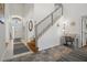 Bright foyer with staircase, neutral walls, and decorative rugs that welcome you into the home at 936 Lake Berkley Dr, Kissimmee, FL 34746