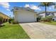 The exterior shows a two-car garage, lawn, shrubbery, and driveway of a two-story home at 936 Lake Berkley Dr, Kissimmee, FL 34746