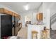 Bright kitchen features tile flooring, wooden cabinets, black appliances and breakfast bar with stools at 936 Lake Berkley Dr, Kissimmee, FL 34746