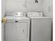 Functional laundry room features a washing machine and dryer at 936 Lake Berkley Dr, Kissimmee, FL 34746