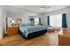 Large bedroom with mirrored wall, ceiling fan, and wood floors, creating a luxurious retreat at 936 Lake Berkley Dr, Kissimmee, FL 34746