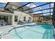 Back of house showing screened-in pool and plenty of seating at 936 Lake Berkley Dr, Kissimmee, FL 34746