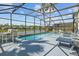 Inviting screened pool area overlooking a serene lake at 936 Lake Berkley Dr, Kissimmee, FL 34746