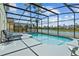 Screened in pool with lake view and plenty of seating at 936 Lake Berkley Dr, Kissimmee, FL 34746