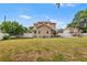 Expansive backyard offering plenty of space and views of the rear of the home at 102 Deen Blvd, Auburndale, FL 33823