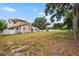 Large backyard featuring mature trees and a view of the two-story home at 102 Deen Blvd, Auburndale, FL 33823
