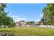 Wide backyard with the house and detached rear structure in the distance at 102 Deen Blvd, Auburndale, FL 33823