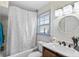 Well-lit bathroom featuring a vanity with a dark wood finish and sleek black fixtures at 102 Deen Blvd, Auburndale, FL 33823