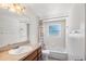 Bright, clean bathroom featuring a shower-tub combo, white fixtures and colorful shower curtain at 102 Deen Blvd, Auburndale, FL 33823