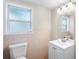 Clean bathroom with a tiled wall, single vanity, and an enclosed toilet area at 102 Deen Blvd, Auburndale, FL 33823