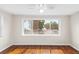Bright bedroom featuring hardwood floors, large windows, and a ceiling fan at 102 Deen Blvd, Auburndale, FL 33823