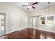 Bedroom featuring hardwood flooring, closet space, and barn-door access to the bathroom at 102 Deen Blvd, Auburndale, FL 33823