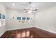 Spacious primary bedroom with wood floors, ceiling fan, and abundant natural light at 102 Deen Blvd, Auburndale, FL 33823
