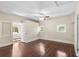 Bedroom with hardwood floors, multiple windows, ceiling fan, and access to sunroom at 102 Deen Blvd, Auburndale, FL 33823