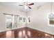 Bedroom with barn-door closet, hardwood flooring, and an adjacent bathroom at 102 Deen Blvd, Auburndale, FL 33823