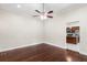 Large bedroom with hardwood flooring and views of the kitchen through the doorway at 102 Deen Blvd, Auburndale, FL 33823