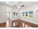 Primary bedroom with hardwood floors, ceiling fan, and access to the ensuite bathroom at 102 Deen Blvd, Auburndale, FL 33823
