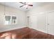 Bedroom featuring hardwood flooring, natural lighting, and closet space at 102 Deen Blvd, Auburndale, FL 33823