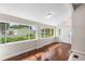 Inviting entryway featuring hardwood floors, vaulted ceiling, and a large window offering plenty of natural light at 102 Deen Blvd, Auburndale, FL 33823