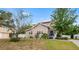 Charming home with light siding, manicured lawn, and a welcoming front entrance featuring a covered porch at 102 Deen Blvd, Auburndale, FL 33823