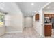 Hallway leading to an open kitchen area with tiled floors and recessed lighting at 102 Deen Blvd, Auburndale, FL 33823