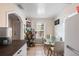 Cozy kitchen with bright walls, small table, open shelves and stainless steel refrigerator at 102 Deen Blvd, Auburndale, FL 33823