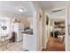 Efficient galley kitchen featuring white appliances and eat in dining area at 102 Deen Blvd, Auburndale, FL 33823