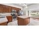 Updated kitchen features stainless appliances, wood cabinets, and a functional center island at 102 Deen Blvd, Auburndale, FL 33823